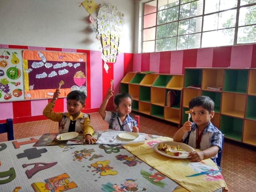 A Joyland child choosing materials from low classroom shelves