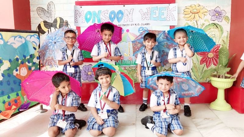 Joyland children in a classroom decorated with umbrellas and rain-themed art