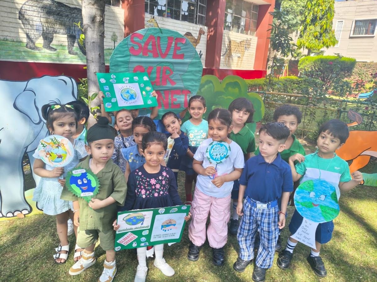 Joyland children standing together on the lawn holding the nature crafts they made