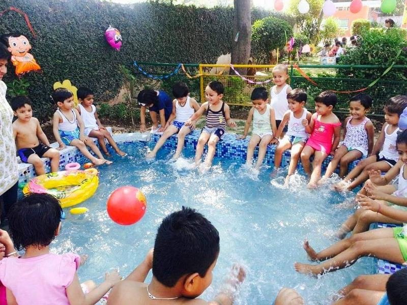 Children splashing their feet at a Joyland pool party