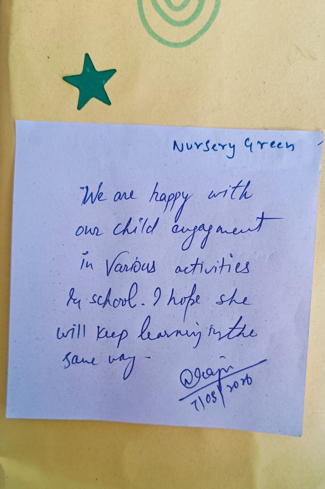 Handwritten parent note on a sticky note