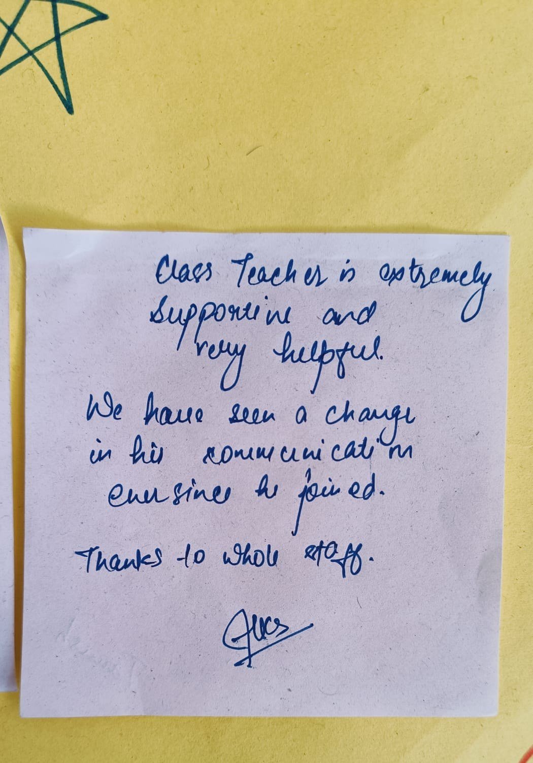 Handwritten parent note on a sticky note